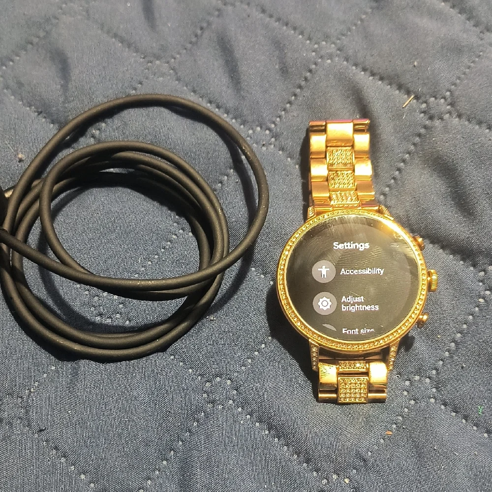 Gold Smartwatch with Black Charging Cable